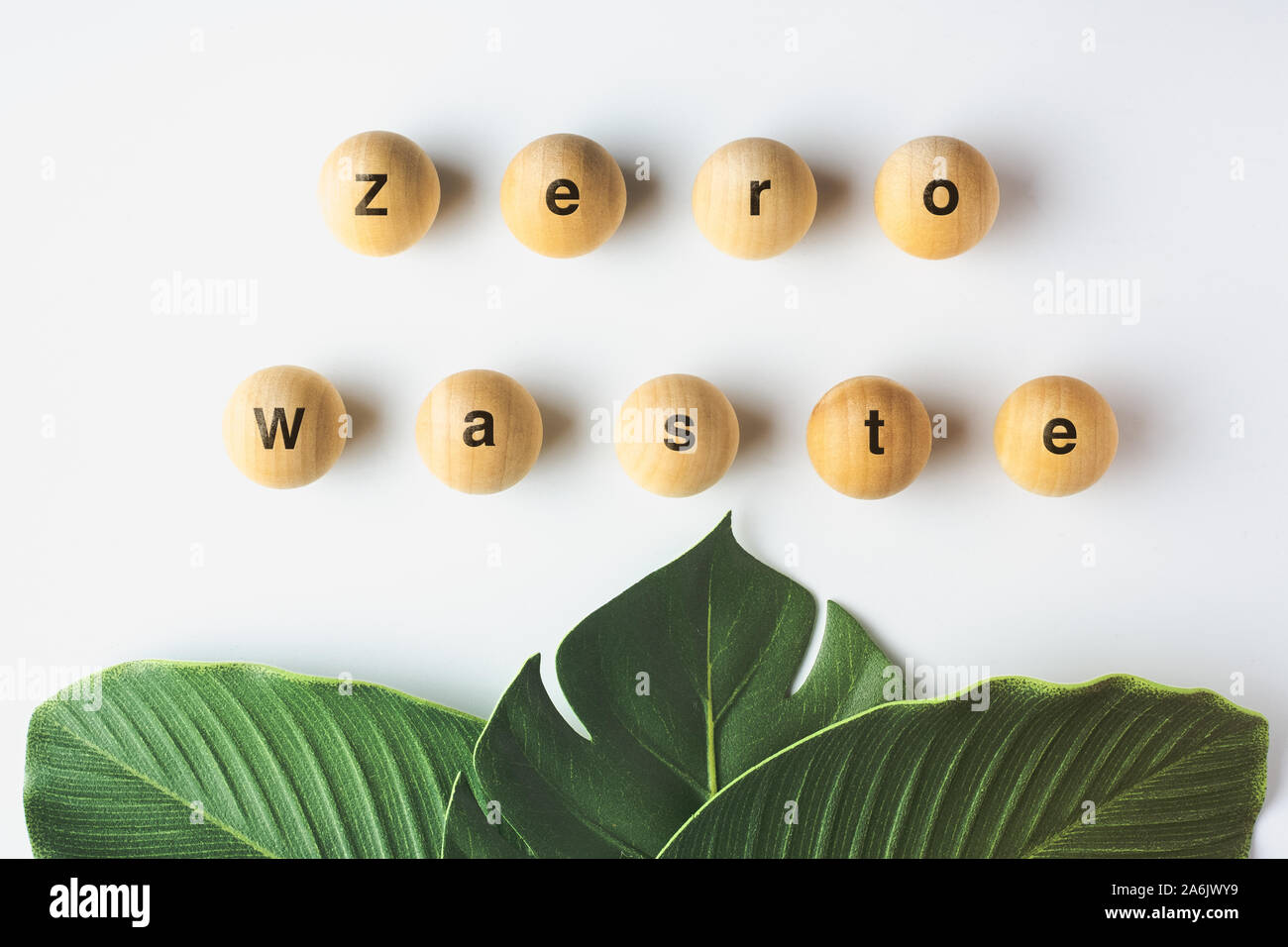 zero waste word on wood block with green leaf on white table,eco friendly and plastic free concept Stock Photo