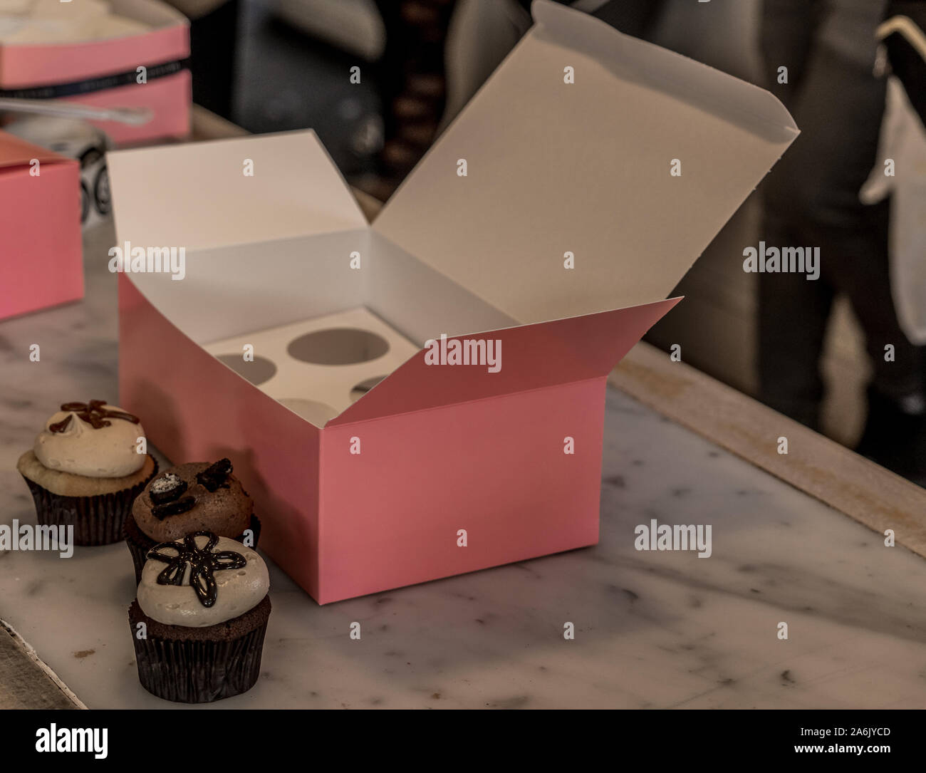 Gourmet cupcakes with a pink box in Gerogetown Stock Photo
