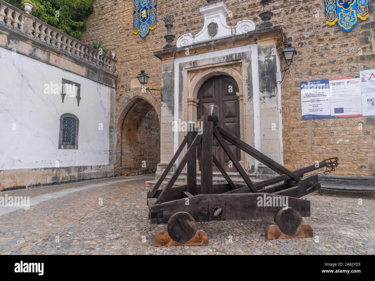Wooden catapult in front of the city gate of Obidos one of the seven wonders of Portugal Stock Photo