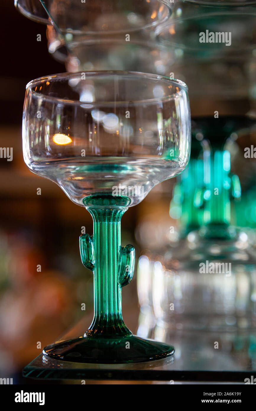 A saguaro stemmed cocktail glass sits on a bar room shelf in Arizona. Stock Photo