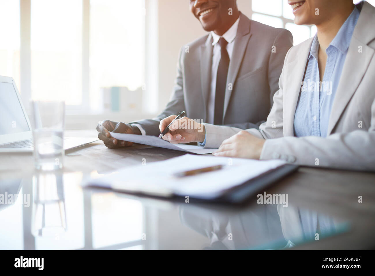 Close up of unrecognizable business people signing contract during ...