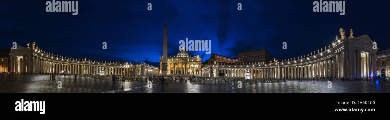 Night panorama of Vatican city. Bernini's colonnade, Maderno's fountain and St. Peter's Basilica at night during blue hour. Stock Photo