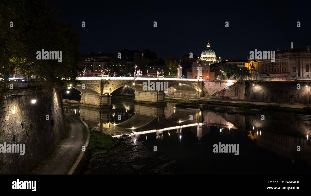 Night picture of Tiber, bridge Ponte Vittorio Emanuele II and dome of  St. Peter's Basilica at the background. Rome at night. Stock Photo