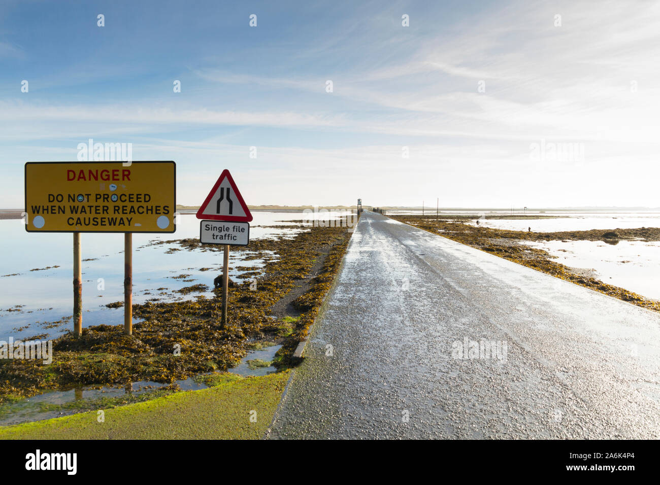 The Causeway during the low tide into Lindisfarne / Holy Island Northumberland UK Stock Photo