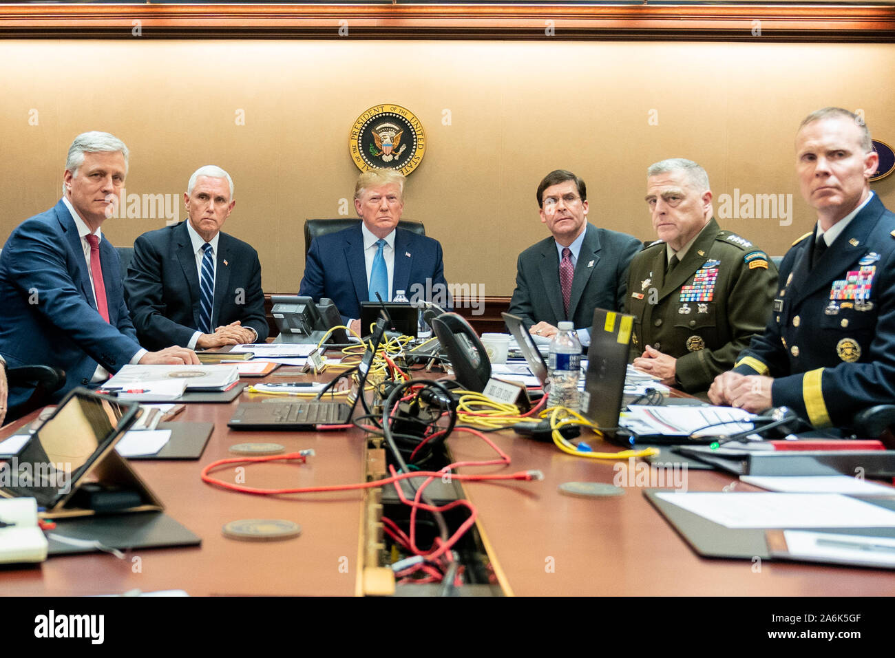 Washington DC, USA. 26th Oct, 2019. In this photo released by the White House, United States President Donald J. Trump is joined by United States Vice President Mike Pence, United States National Security Advisor Robert C. O'Brien, left; United States Secretary of Defense Dr. Mark T. Esper, United States Army General Mark A. Milley, Chairman of the Joint Chiefs of Staff, and Brigadier General Marcus Evans, Deputy Director for Special Operations on the Joint Staff right, Saturday, October 26, 2019, in the Situation Room of the White House in Washington, DC monitoring developments as U.S. Specia Stock Photo