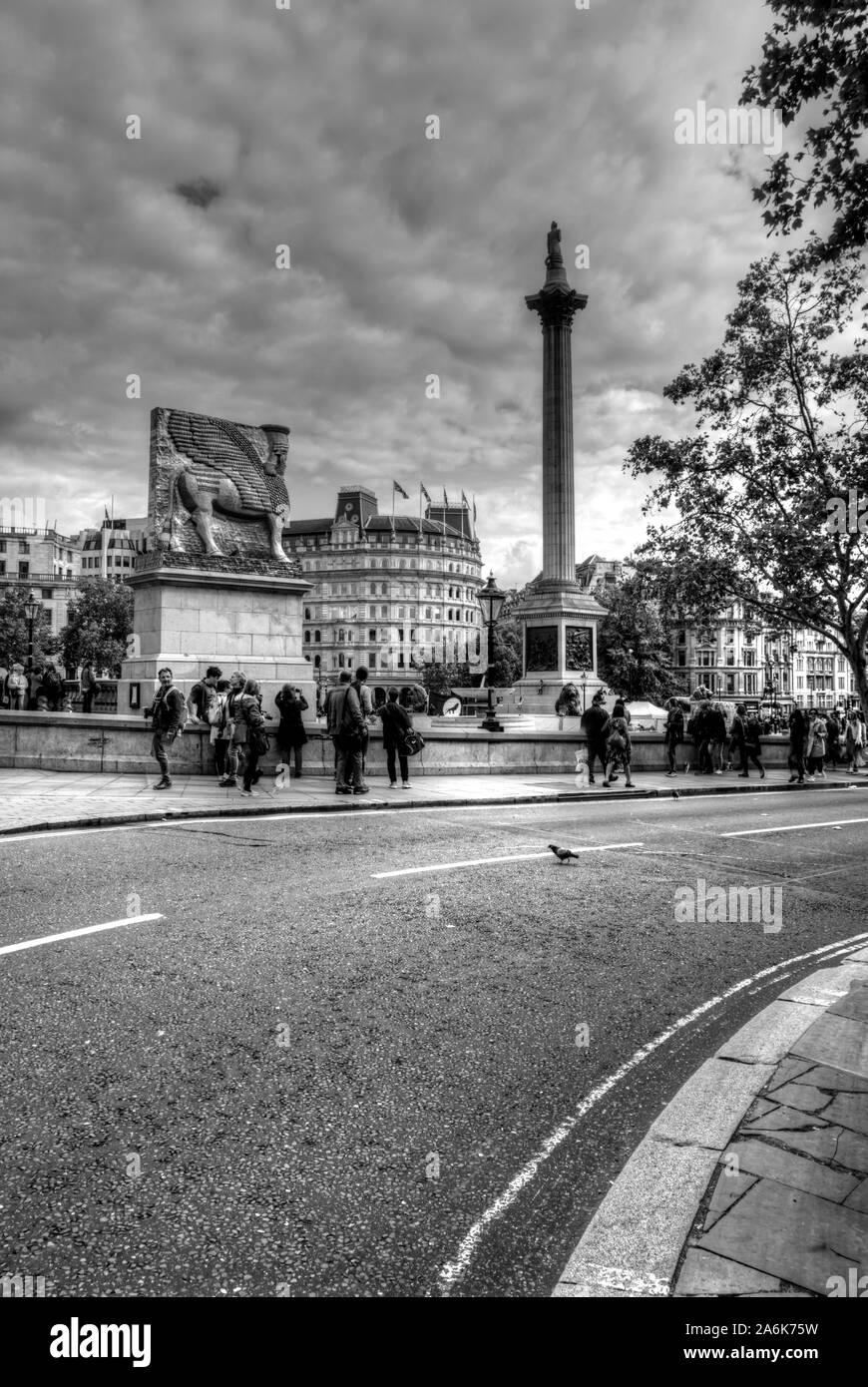 London, United Kingdom - September 7, 2019: View of numerous tourists walking some motion blurred within Trafalgar Square with Nelson's Column and Fou Stock Photo