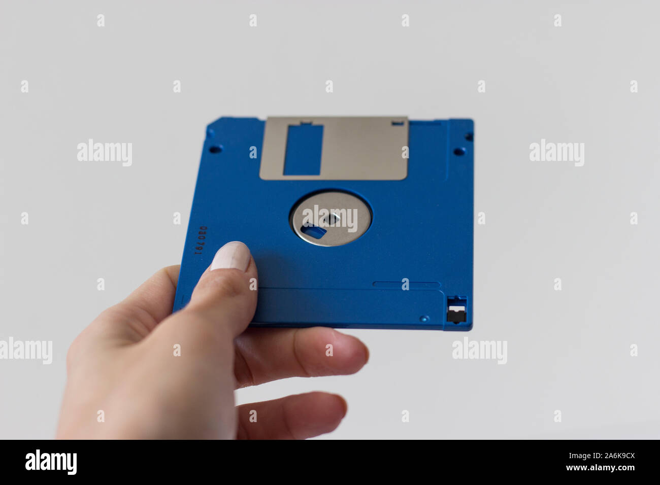 Holding Blue Floppy A disks isolated on white background.Disk storage Stock Photo