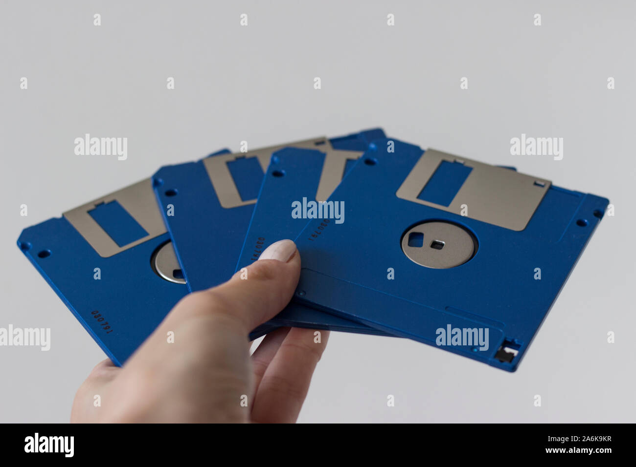Holding Blue Floppy A disks isolated on white background.Disk storage Stock Photo