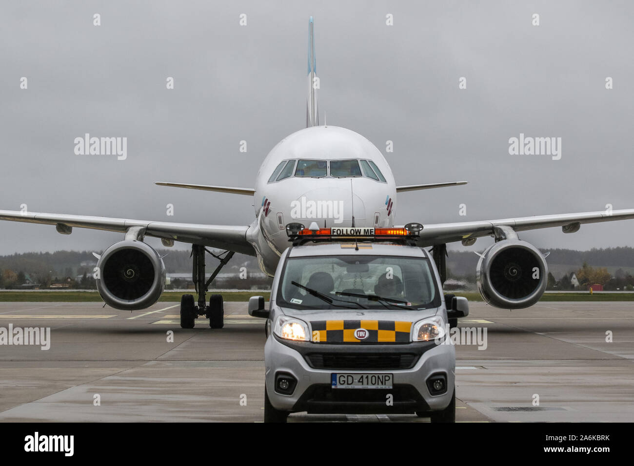 Gdansk, Poland 27th, Oct. 2019 Eurowings (Lufthansa group) Airbus A319-132 (reg. No. D-AGWU) taxiing at Gdansk Lech Walesa Rebiechowo GDN airport following a 'Follow me' Fiat Qubo car  is seen in Gdansk, Poland on 27 October 2019  Eurowings lines inaugurated Gdansk - Dusseldorf (Germany) route, and will operate on  it 4 times weekly. © Vadim Pacajev / Alamy Live News Stock Photo