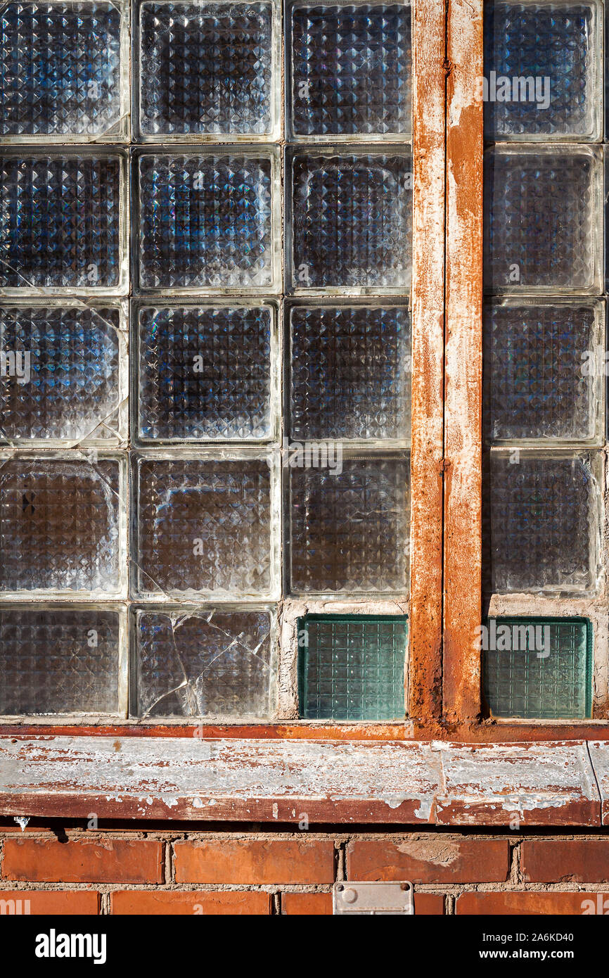 Red brick wall with glass block window. Architecture detail Stock Photo