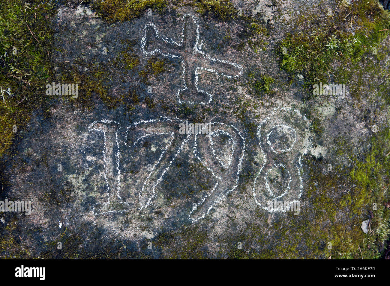 Cross mark which denotes forest border, year 1798, engraved in rock Stock Photo