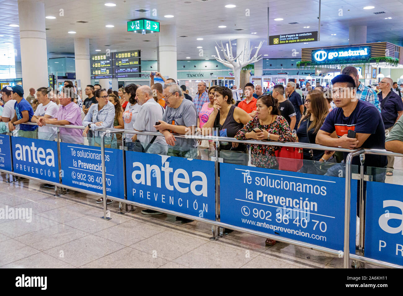 Barcelona Spain,Catalonia Barcelona-El Prat Josep Airport BCN,international arrivals,terminal,crowd control barrier,awaiting waiting arriving passenge Stock Photo