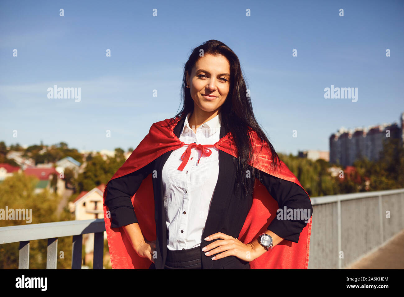 Successful superhero businesswoman on a background of blue sky Stock Photo
