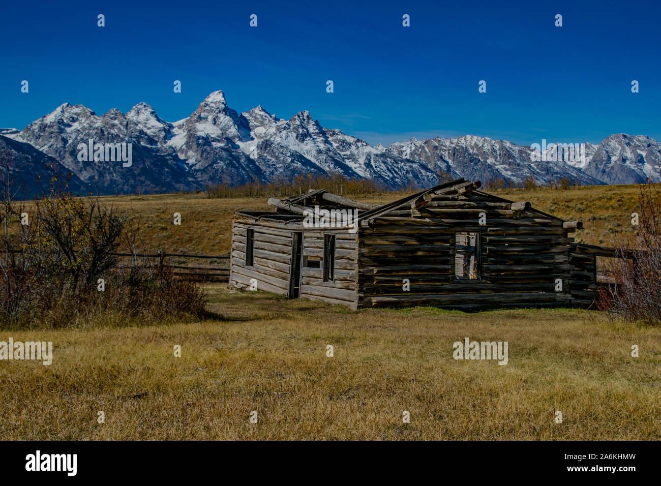 An Old, Abandoned Building with the Grand Tetons in the Background Stock Photo