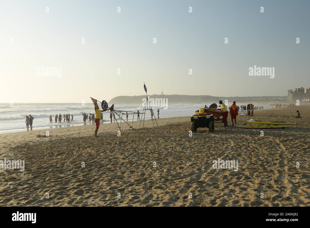 Durban, KwaZulu-Natal, South Africa, landscape, adult male lifeguards preparing equipment on beach for duty, occupations, water safety, drowning Stock Photo