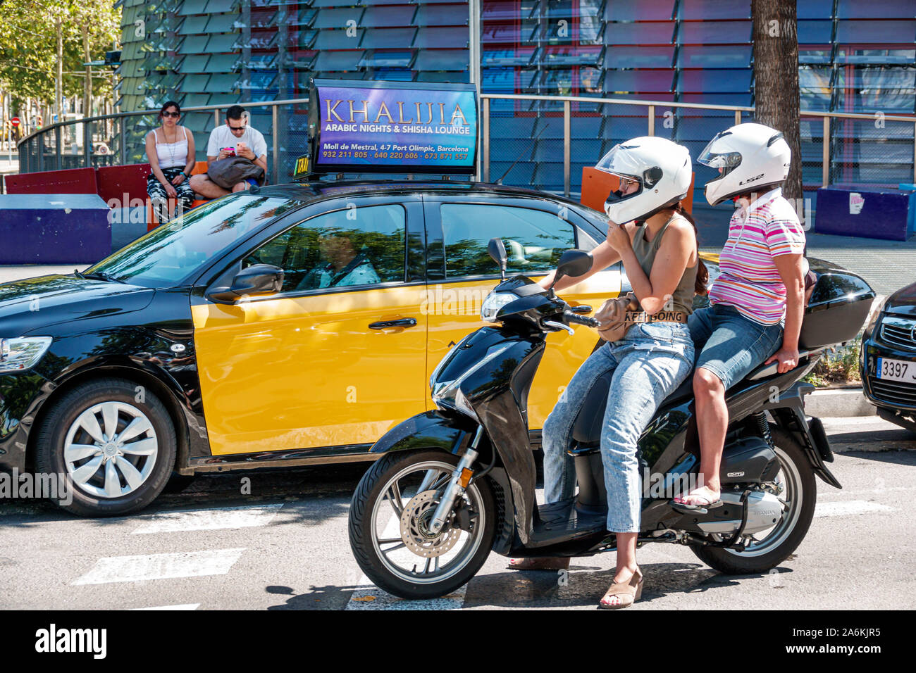 Barcelona Spain,Catalonia Catalunya,El Poblenou,Avinguda Diagonal,avenue,traffic,woman women female lady adult adults,riding motorcycle motorcycles,st Stock Photo