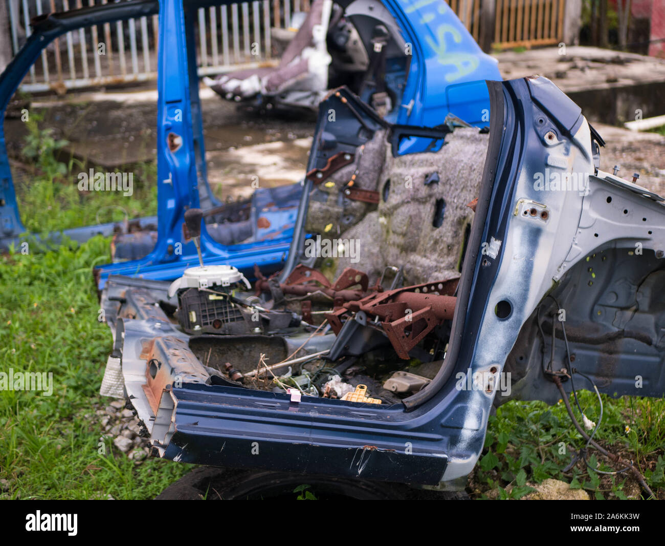 Old rusty half cut car by the road side after the accident at the workshop Stock Photo