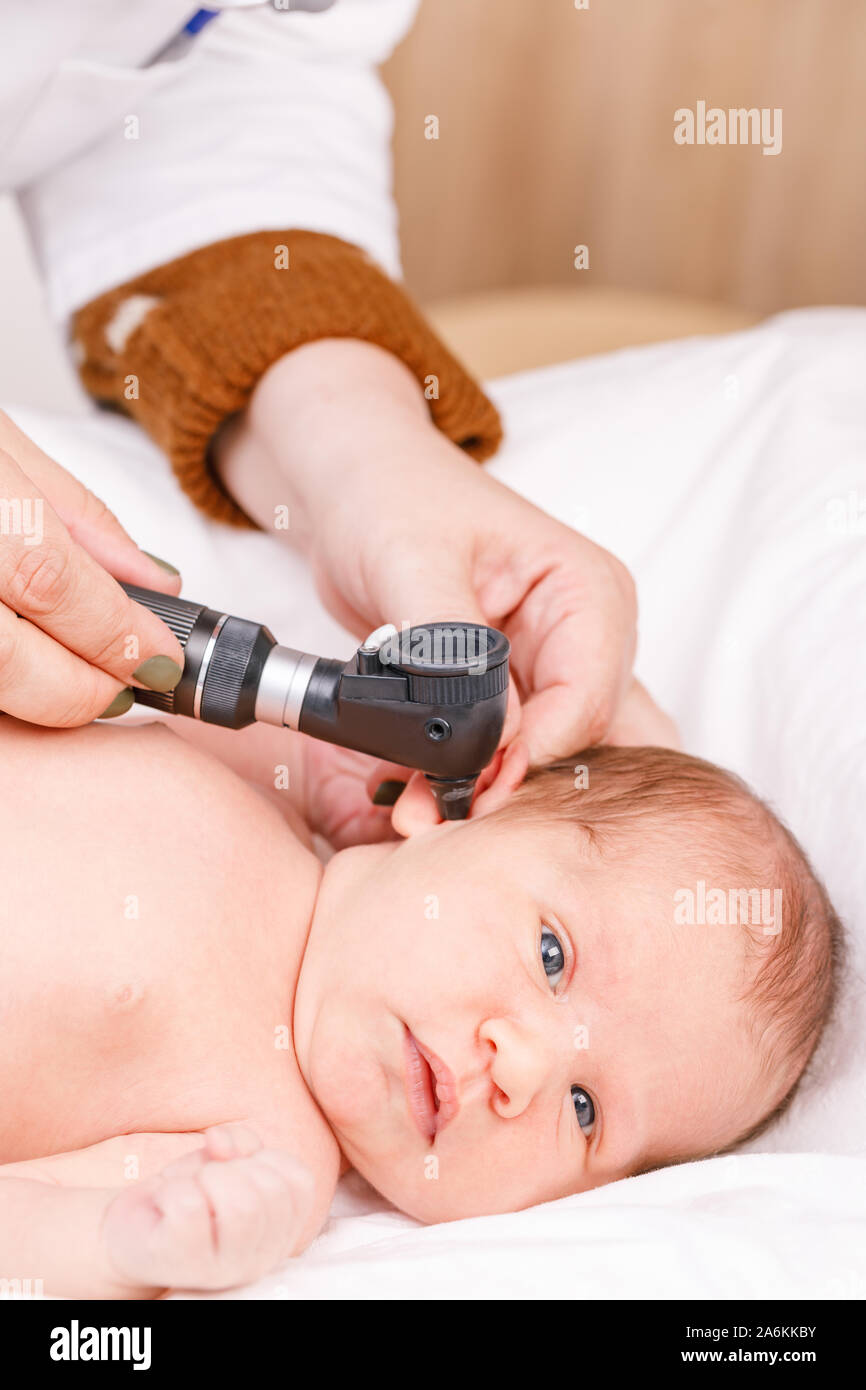 Pediatrician Examines Two Week Old Baby s Ear In Pediatric Clinic Pediatrician Examines Two Week Old Baby s Ear In Pediatric Clinic