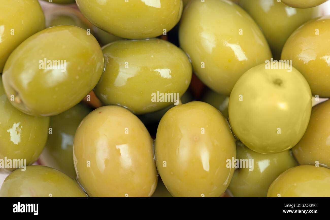 Green olives background in brine close up, top view Stock Photo Alamy