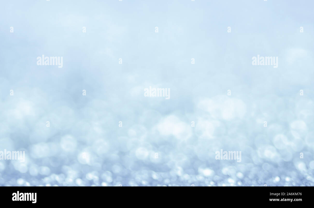 Abstract winter snow Christmas light blue background with bokeh. Defocused sparkle snowflakes Stock Photo