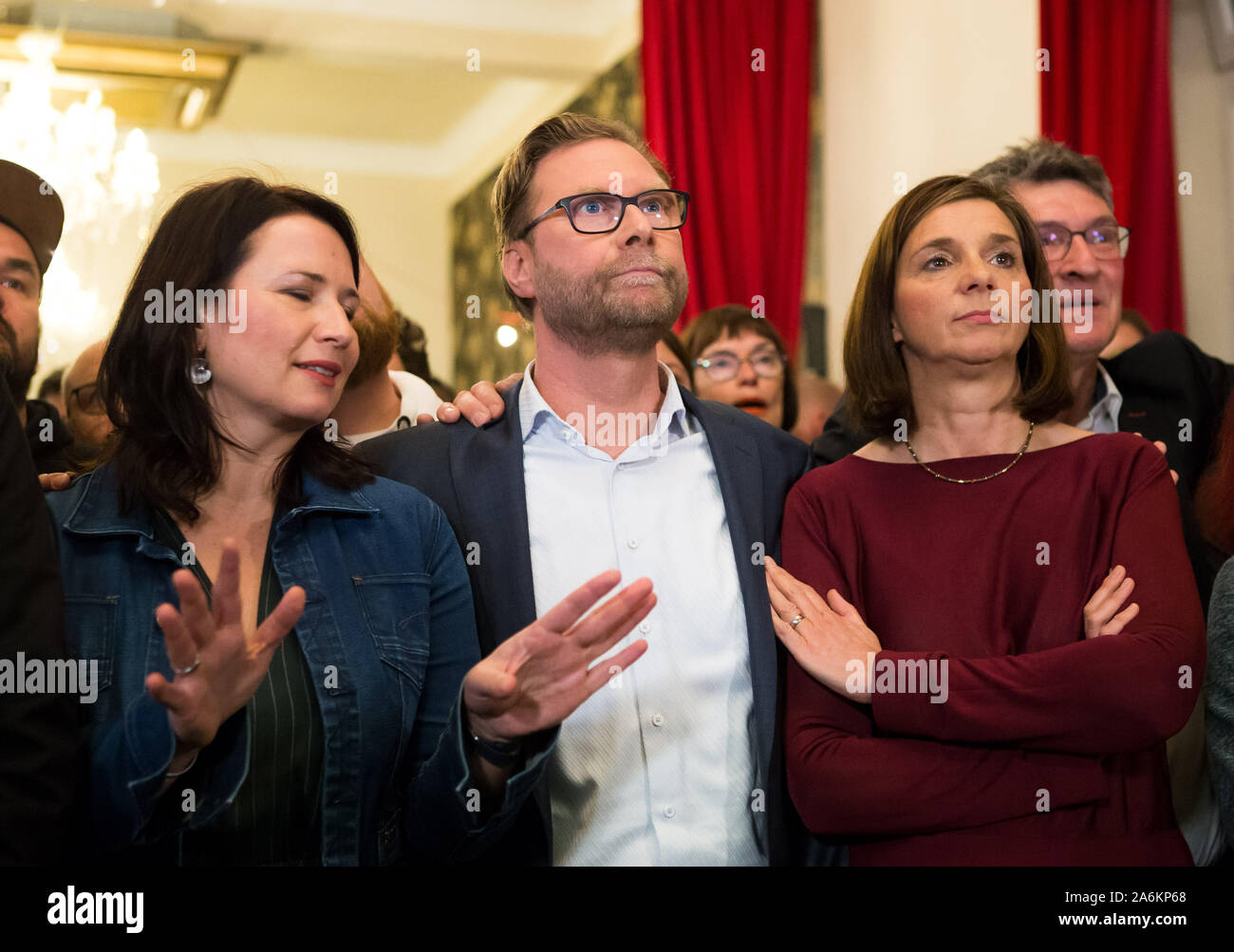 Erfurt, Germany. 27th Oct, 2019. Anja Siegesmund (l-r), the leading candidate of the party Bündnis 90/Die Grünen, Dirk Adams, leading candidate of Bündnis 90/Die Grünen, and Katrin Göring-Eckardt, parliamentary party leader of the Greens in the Bundestag, consider the first projections at the Green election party. Credit: Daniel Naupold/dpa/Alamy Live News Stock Photo