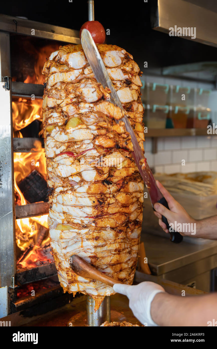 Chef cutting with doner knife Traditional Turkish Doner Kebab meat
