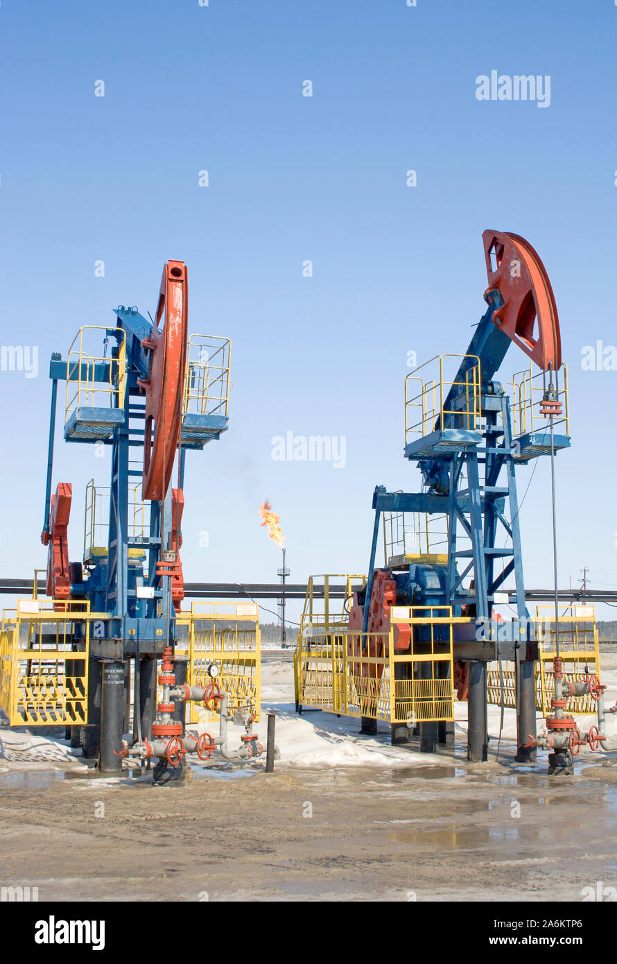 Oil pumps and gasl torch. Oil industry. Gas industry. Blue sky Stock Photo