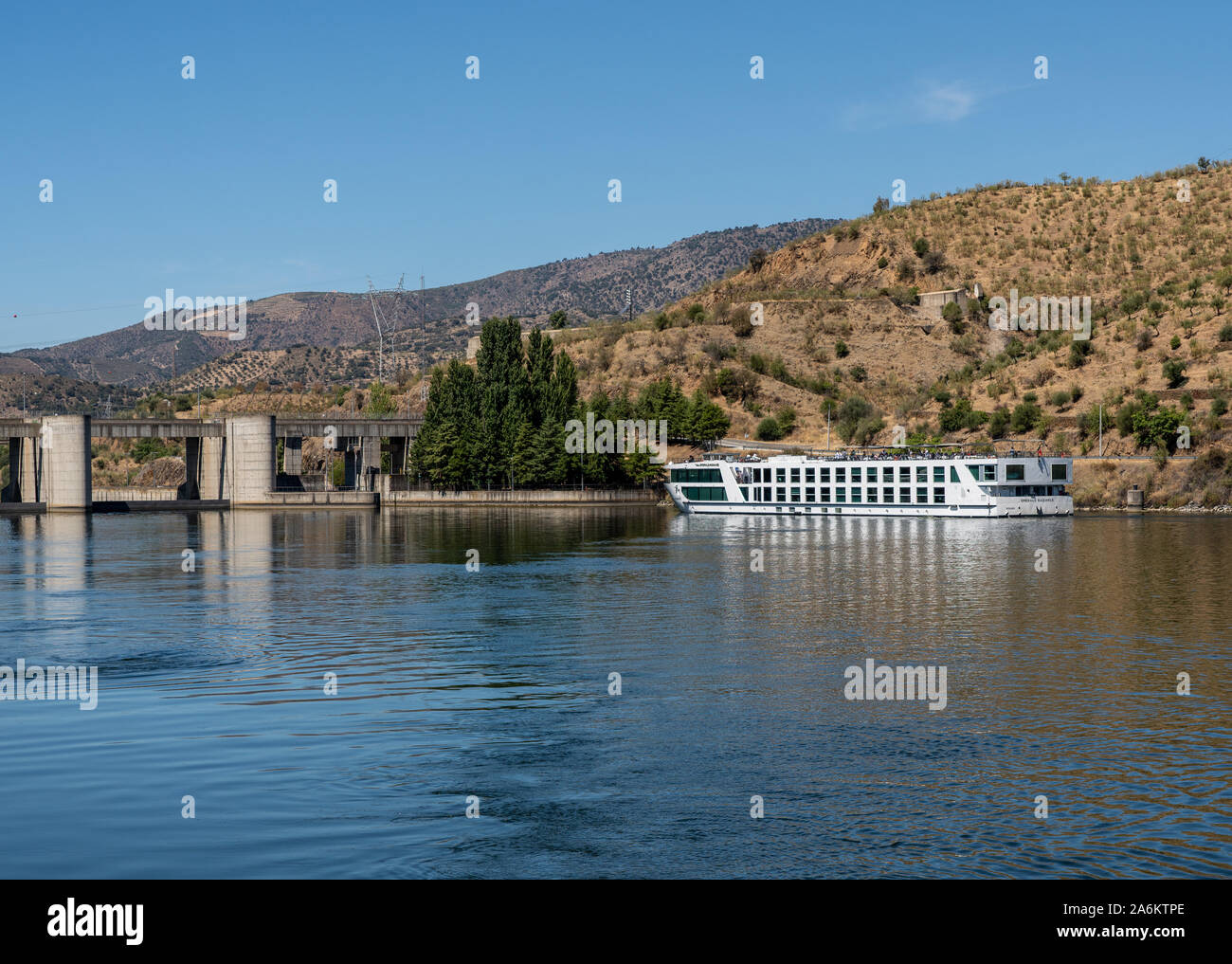 Bracanca, Portugal - 14 August 2019: Barragem do Pocinho dam on the River Duoro with Emerald Radiance about to enter lock Stock Photo