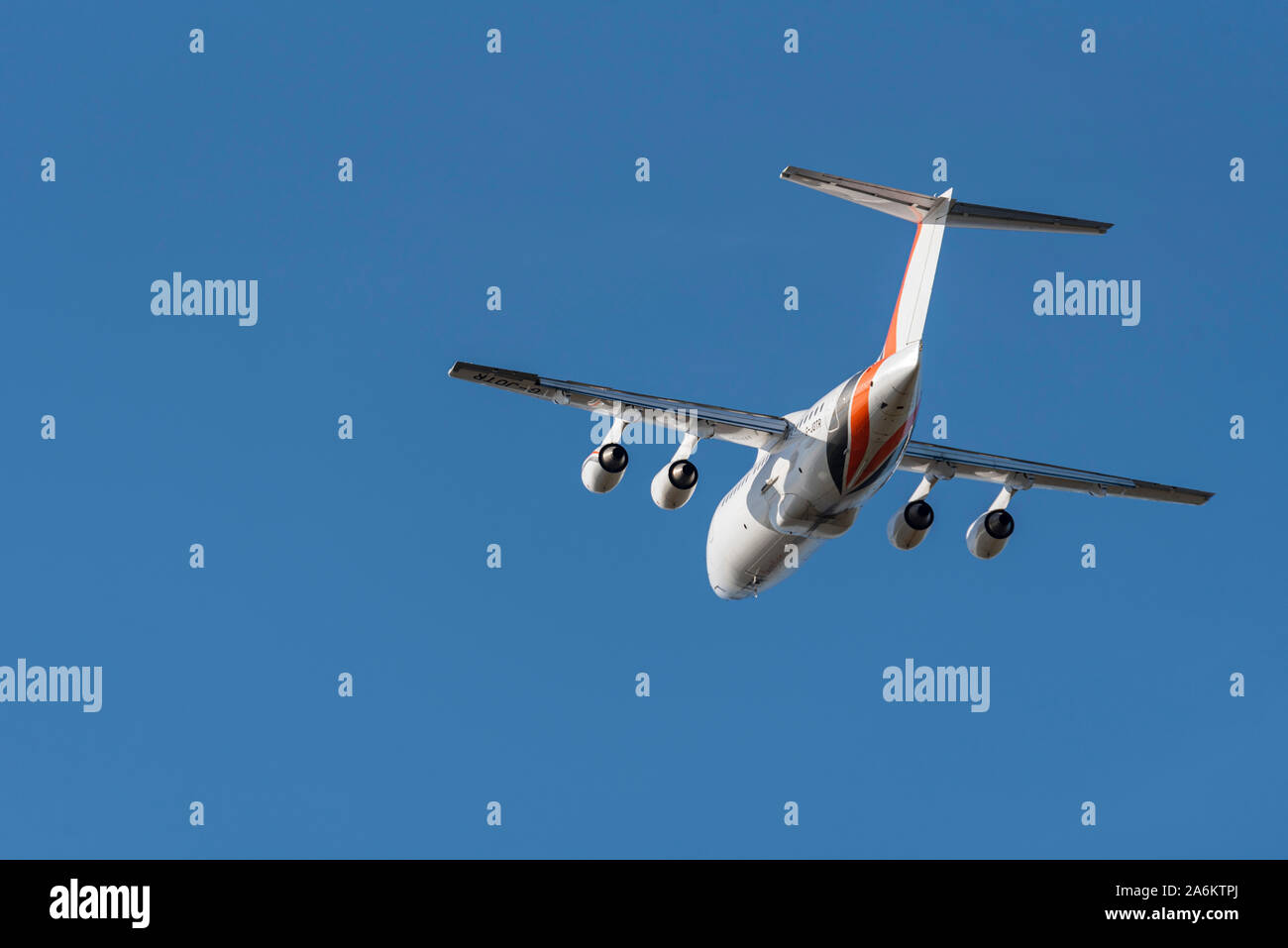 JOTA Aviation BAE Avro RJ85 taking off at London Southend Airport, Essex, UK. Ad hoc charter airline jet plane climbing into blue sky. Space for copy Stock Photo