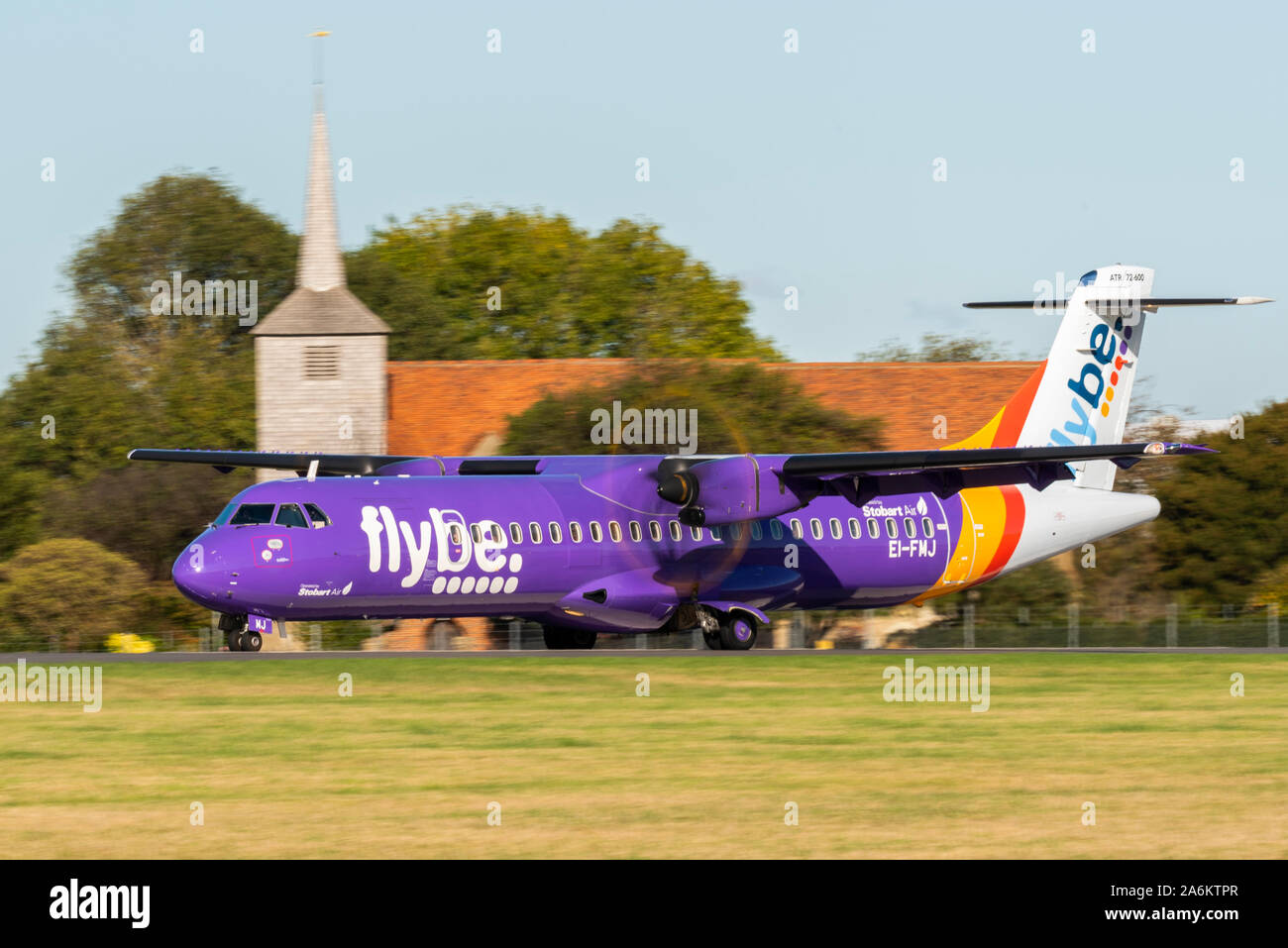 Flybe ATR 72 turboprop airliner plane taxiing after landing at at London Southend Airport, Essex, UK. Church. Purple scheme. Stobart Air airline Stock Photo
