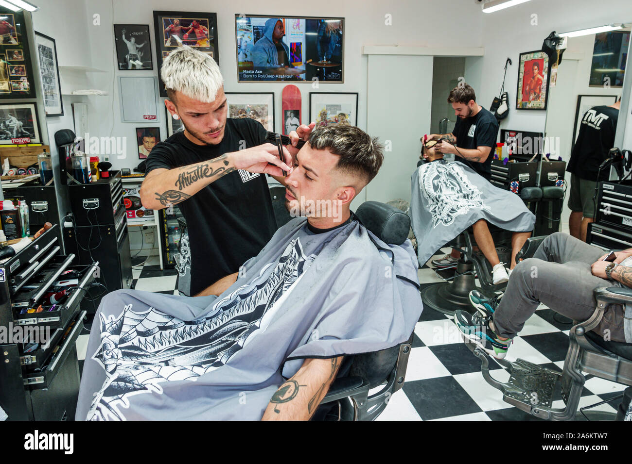 Barcelona Spain,Catalonia Ciutat Vella,Carrer dels Tallers,barbershop,barber,hairdresser,man,young adult,cutting hair,working,client,trendy haircut,bl Stock Photo