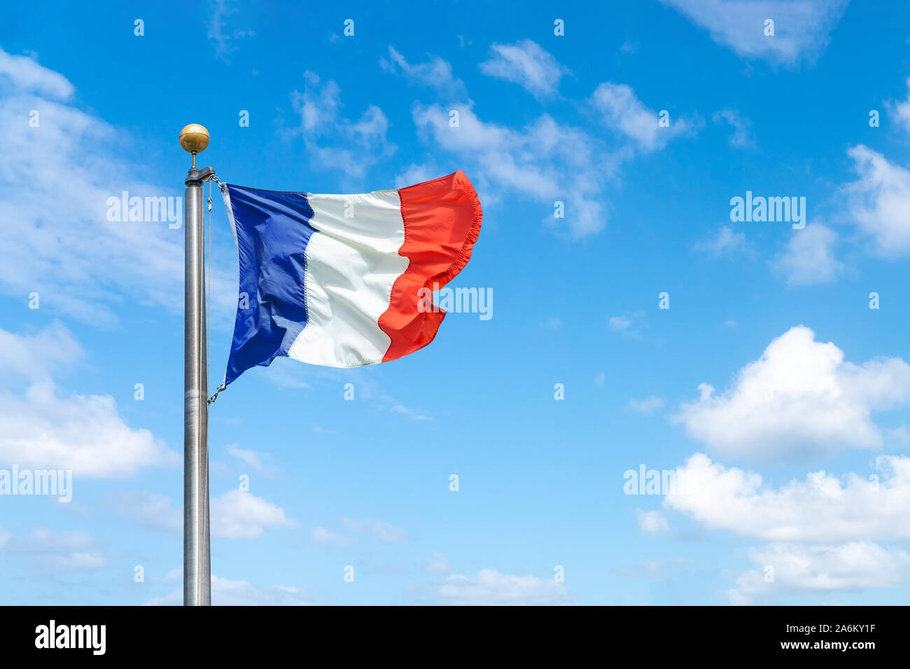 French flag against a blue sky background Stock Photo