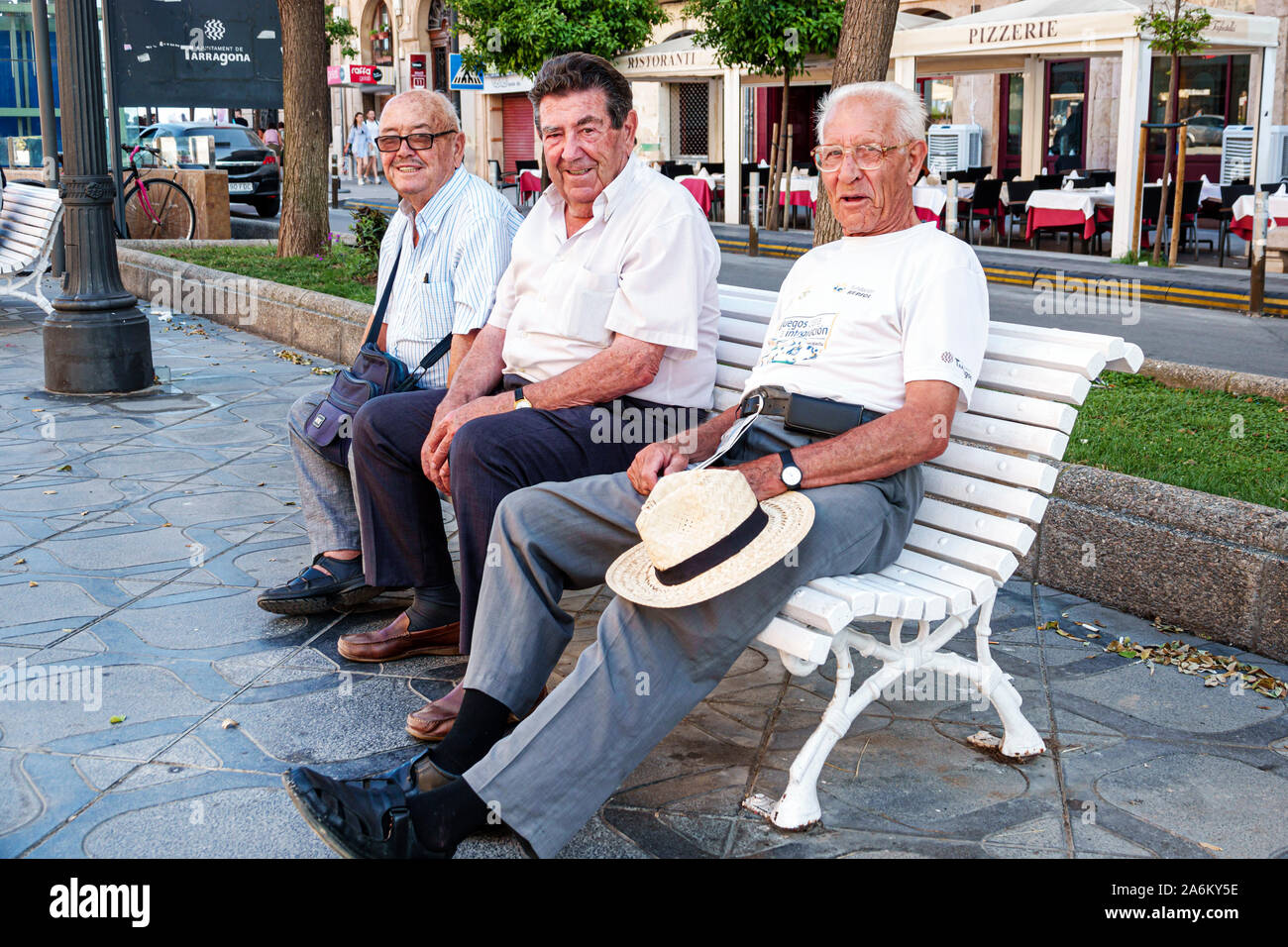 Tarragona Spain,Hispanic Latin Latino,Catalonia Catalunya,Rambla Nova,pedestrian promenade,park bench,man men male adult adults,men,mature,senior seni Stock Photo