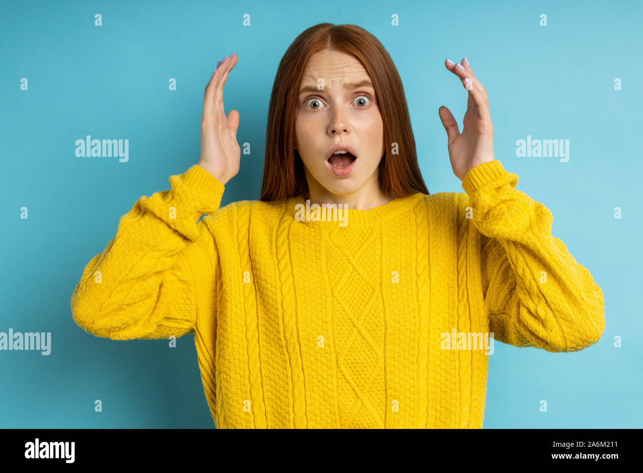 Photo of stunned scared young caucasian redhead woman with worried ...