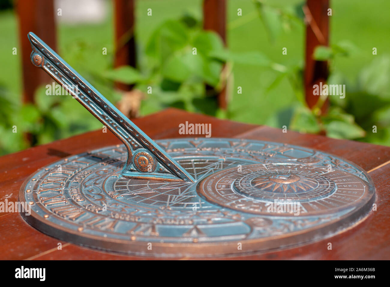 Antique sundial with a beautiful dial and ornament. The bronze oxidized