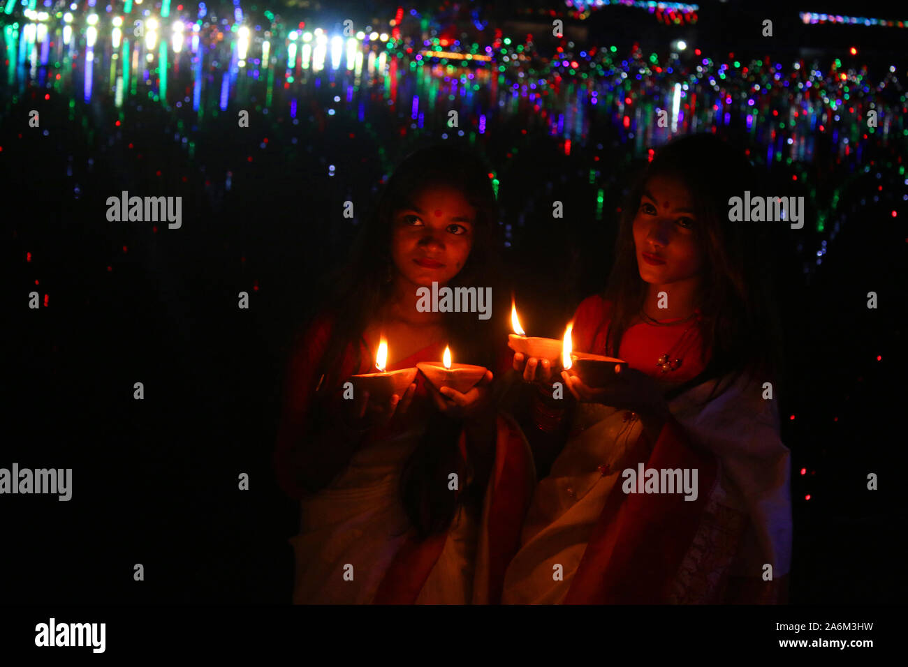 Two Bangladeshi Young Girl Hold Oil Lamps As They Poses For A Photo During The Diwali Festival At A Temple In Dhaka The Diwali Festival Of Lights Symbolizes The Victory Of Good Over