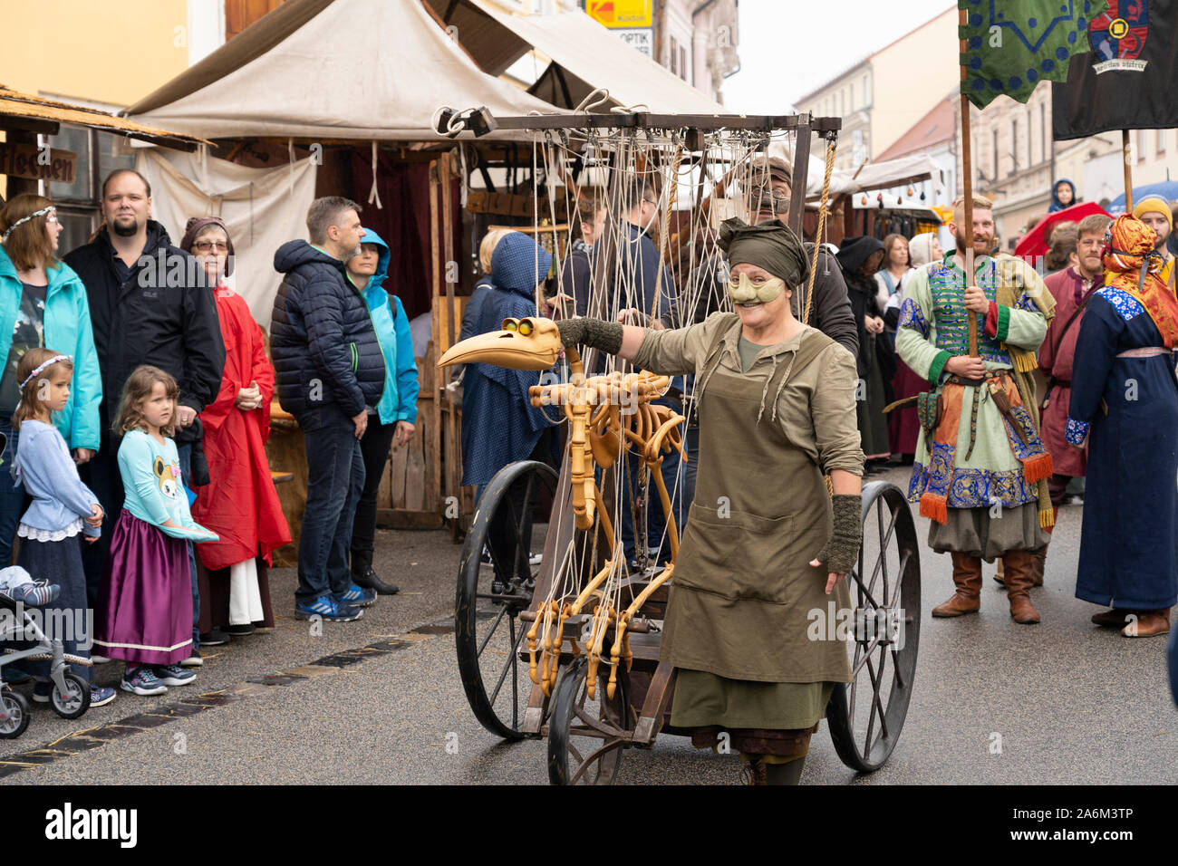 A woman with a mask and a bone marionette puppet at Eggenburg Medieval Festival, Austria's largest medieval event Stock Photo