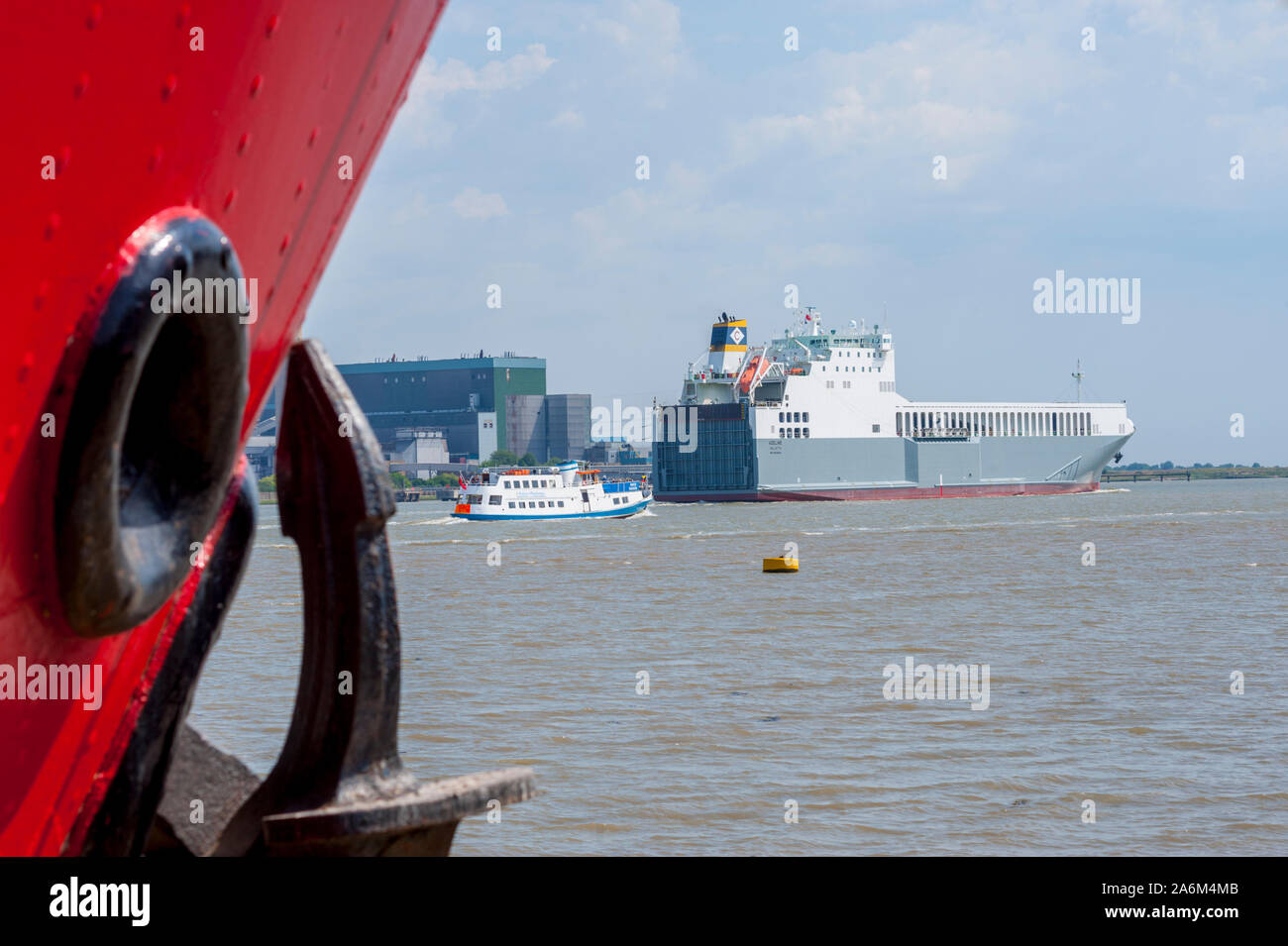 Ship sailing down the thames from Gravesend Kent with MV Pocahontas and With the old Tilbury power station in the background, (Demolished 2019) Stock Photo
