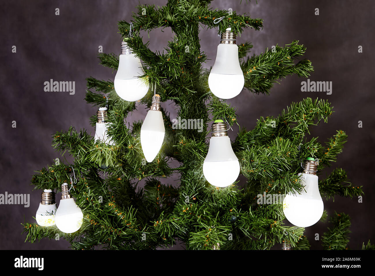The Christmas tree is decorated with household LED electric lamps in ...