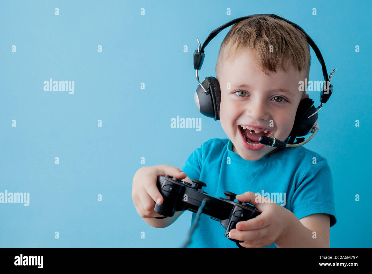 Little kid boy 2-3 years old wearing blue clothes hold in hand joystick ...