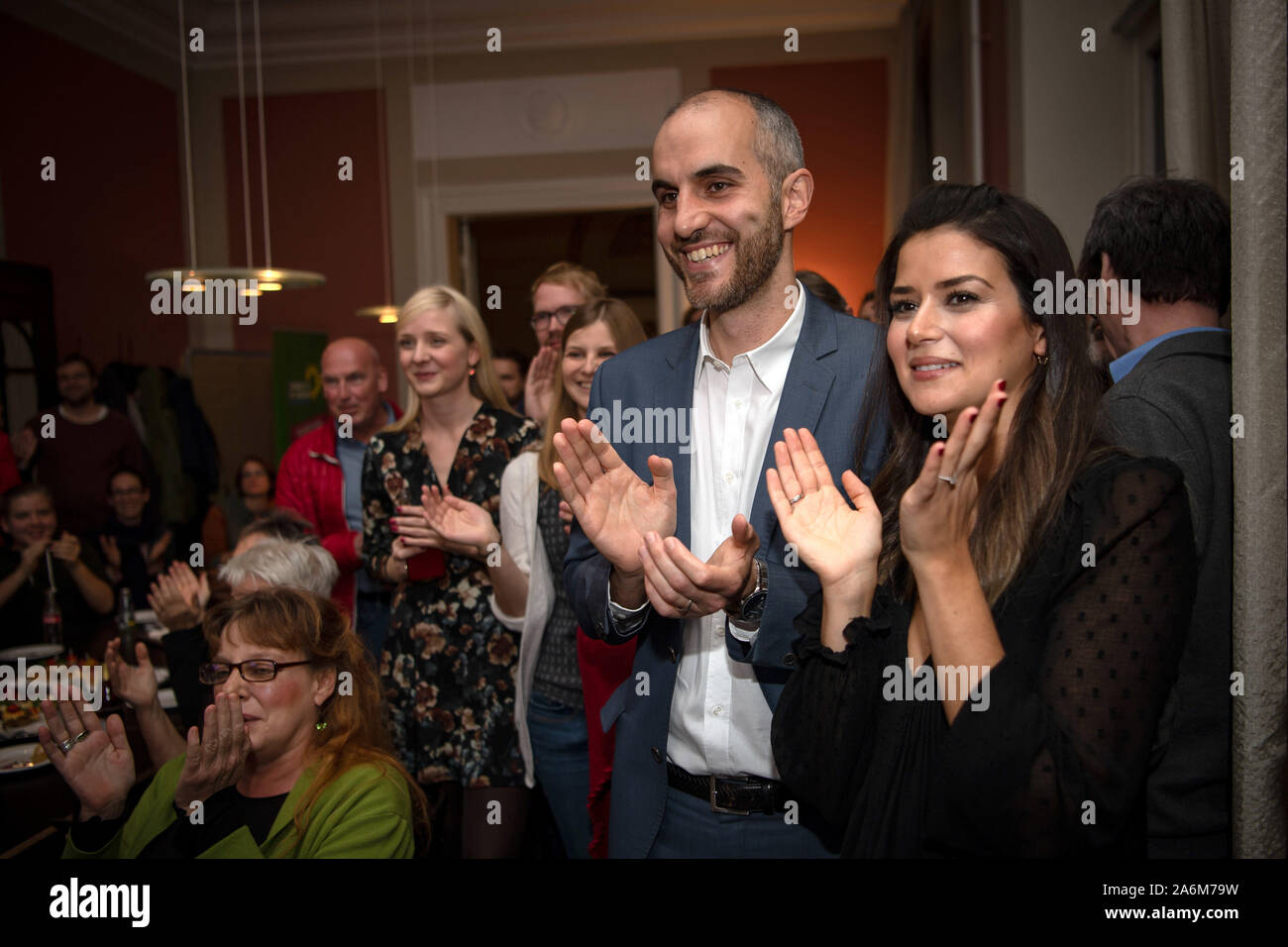 27 October 2019, Lower Saxony, Hanover: Belit Onay (2nd from right), Green top candidate in the mayoral election, and his wife Derya cheer after the announcement of the first election results. For the first time in more than 70 years, the SPD will no longer be the mayor of Hanover. In the first ballot on Sunday, Green candidate Belit Onay and CDU candidate Eckhard Scholz won the second ballot in two weeks, with only 49 votes between them. Social Democrat Marc Hansmann came in third. Voter turnout was 46.5 percent. The early election in Hanover was triggered by the City Hall affair. Photo: Sina Stock Photo