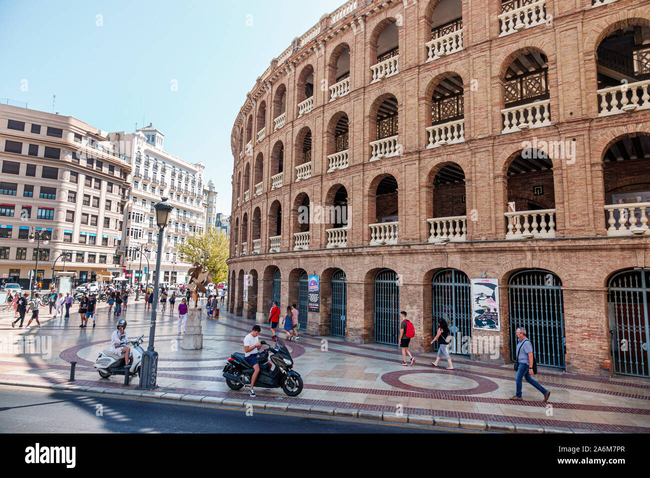 Valencia Spain,Plaza de Bous,bullring,1850,neoclassical style architecture,exterior,arches,by Sebastian Monleon Estelles,pedestrians,ES190831035 Stock Photo