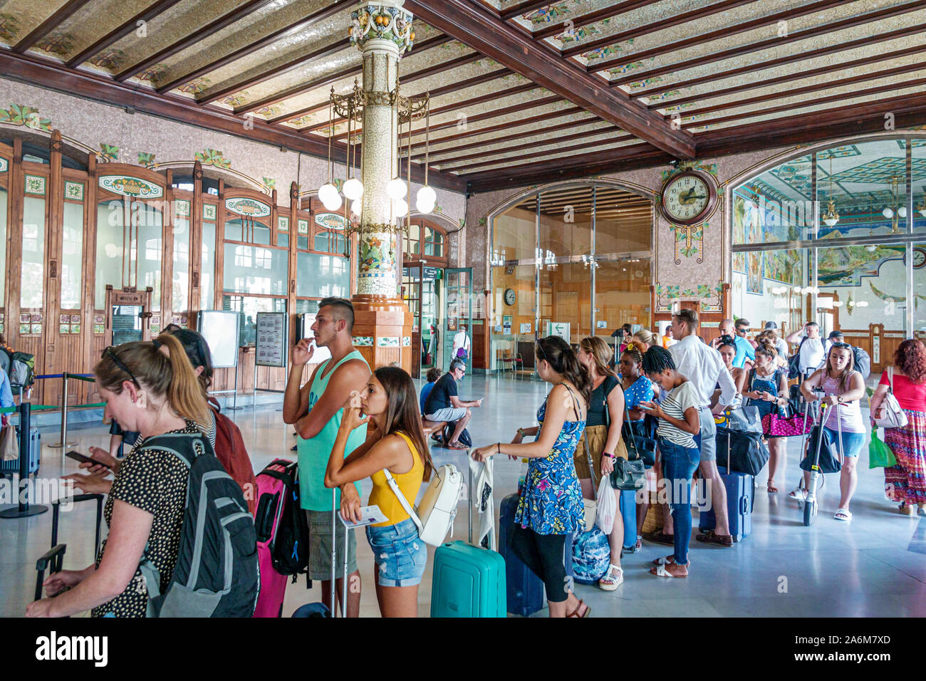 Valencia Spain,Estacio del Nord,Renfe train railway station,ticket windows,long line,queue,inside interior,riders passengers,commuters,woman,man,Hispa Stock Photo