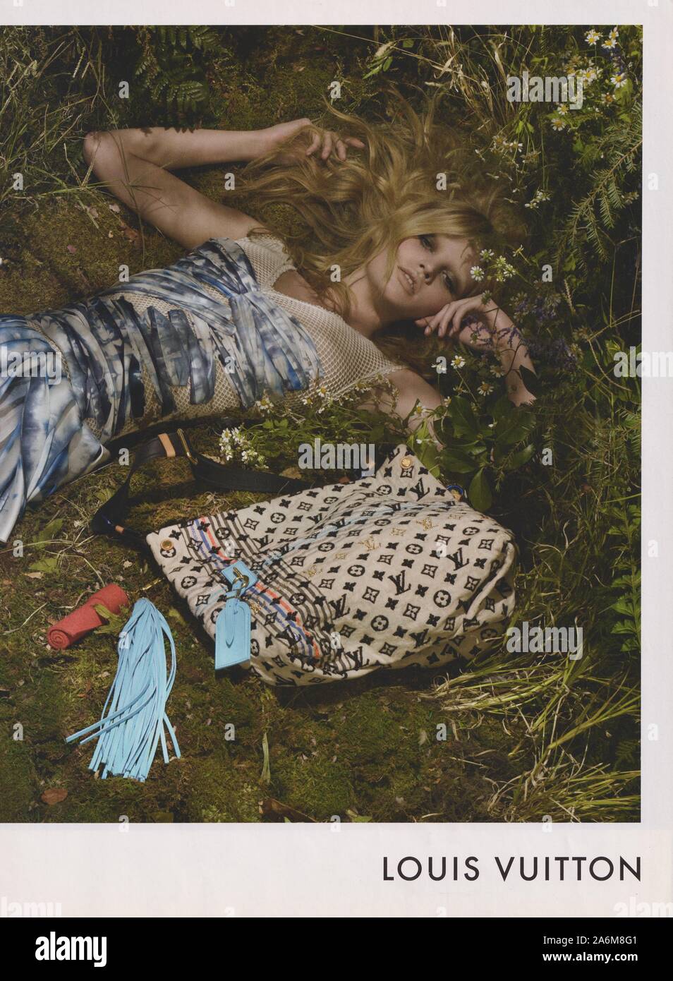 poster advertising Louis Vuitton handbag with Lara Stone in paper