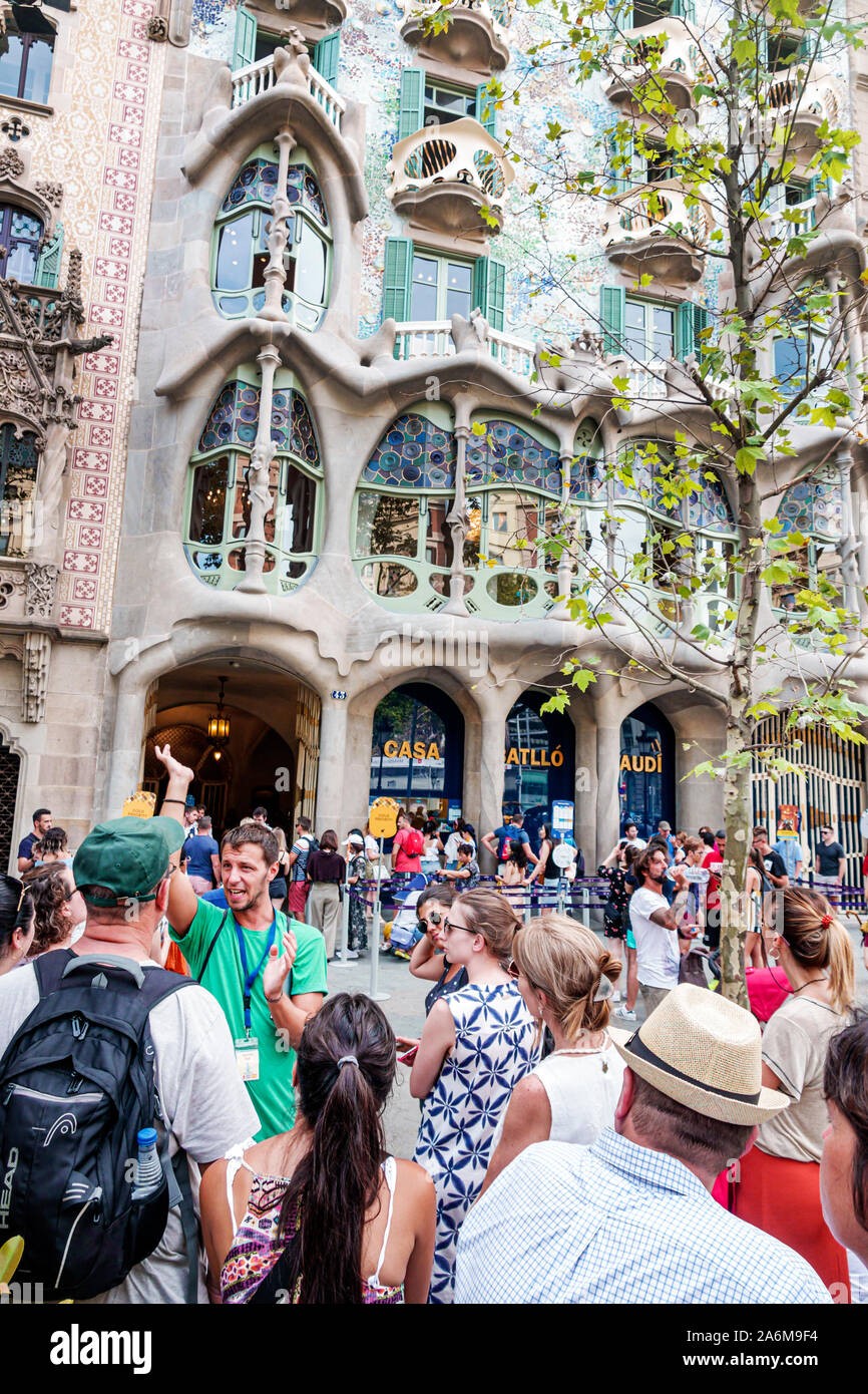 Barcelona Spain,Catalonia Passeig de Gracia,Casa Batllo,exterior,modernist architecture,by Antoni Gaudi,landmark,tour guide,speaking,man,woman,ES19090 Stock Photo