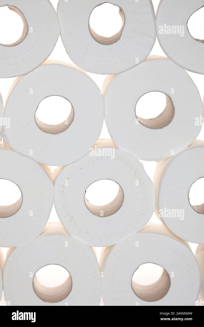 Toilet rolls piled up on white background Stock Photo