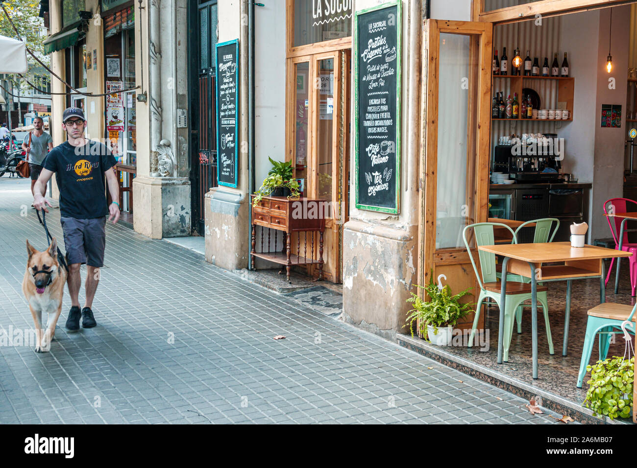 Barcelona Spain,Catalonia Sant Antoni,La Sucursal, restaurant,cafe,sidewalk,man,walking dog,muzzle,Hispanic,ES190902086 Stock Photo