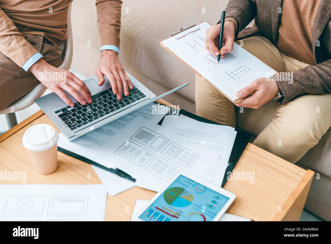 Programmers or designers of software working with online data and papers Stock Photo