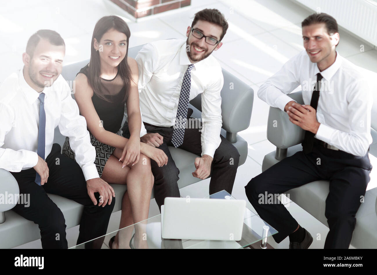 friendly business team sitting in office lobby Stock Photo - Alamy