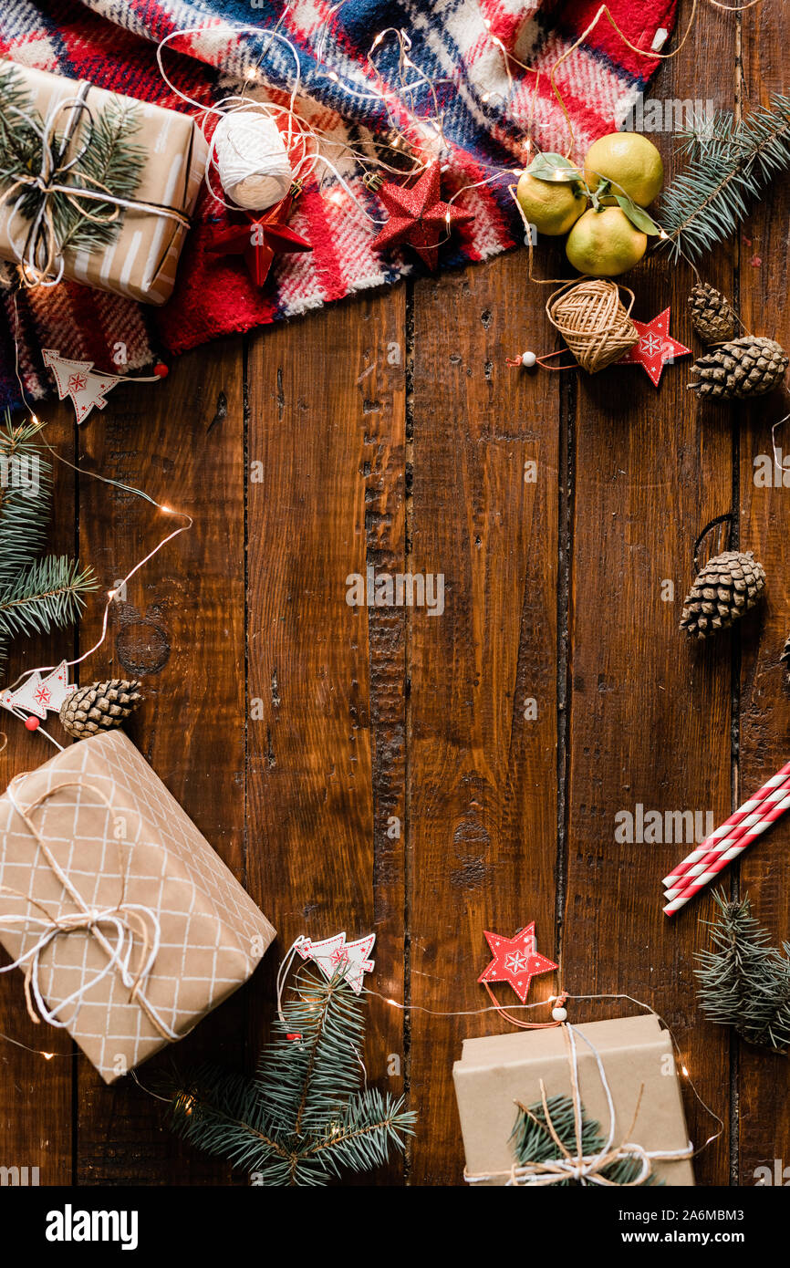 Wrapped giftboxes, garlands, Christmas decorations, pinecones and conifer Stock Photo